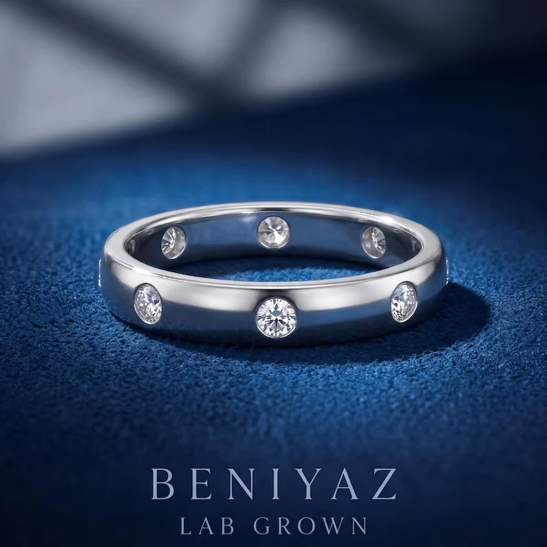 3.4mm flush set lab grown diamond eternity wedding band with eight round diamonds in a smooth comfort-fit profile.