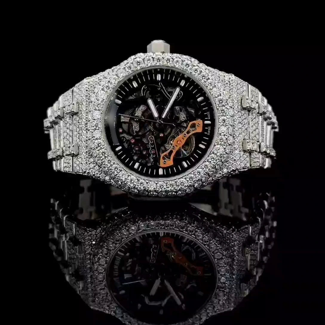 Moissanite iced out skeleton watch with rhodium automatic movement and round cut stones.